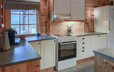 a kitchen with white cabinets and a stove top oven at Lovely Home In Bjorli With Wifi in Bjorli