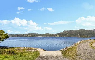 a large body of water with mountains in the background at 3 Bedroom Beautiful Home In Torvikbukt in Torvikbukt