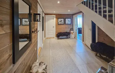 a hallway with a staircase and a dog in a house at 5 Bedroom Nice Home In Edland in Vågsli
