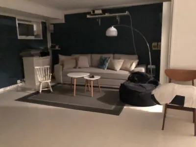 a living room with a couch and a table and chairs at Koselig rekkehus med tre soverom in Trondheim