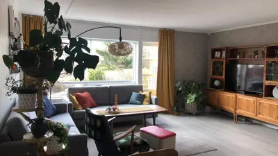 a living room with a couch and a table at Koselig rekkehus med tre soverom in Trondheim