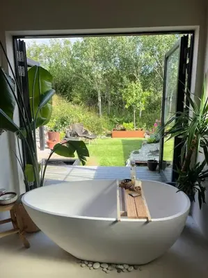 a large white bath tub in front of a window at Vakreste plass og beliggenhet! in Trondheim