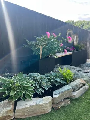 a garden with pink flowers and plants and rocks at Vakreste plass og beliggenhet! in Trondheim