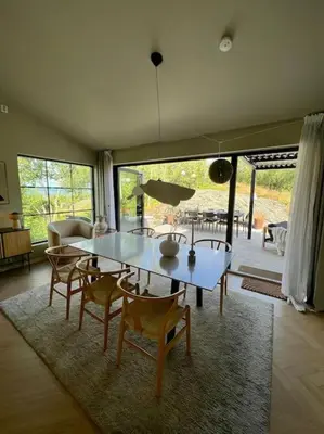 a dining room with a table and chairs in a living room at Vakreste plass og beliggenhet! in Trondheim