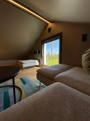 a bedroom with two beds and a large window at Leilighet på to plan nyoppusset sentralt på Tyholt Trondheim in Trondheim