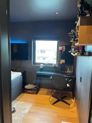 a room with a desk and a bed and a window at Leilighet på to plan nyoppusset sentralt på Tyholt Trondheim in Trondheim