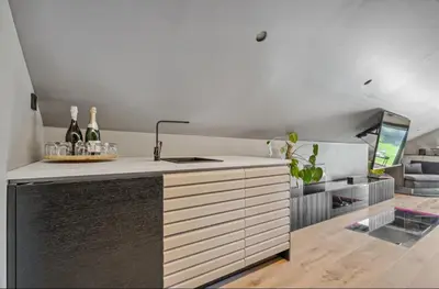 a kitchen with a counter with wine bottles on it at Leilighet på to plan nyoppusset sentralt på Tyholt Trondheim in Trondheim