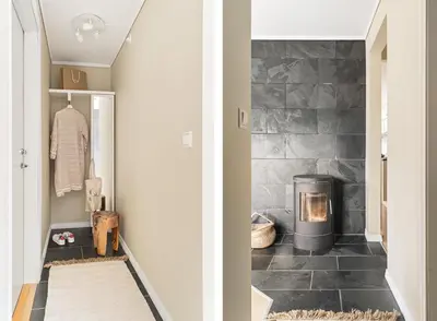 a hallway with a stone fireplace in a house at Sentral leilighet med parkering og peis in Bergen