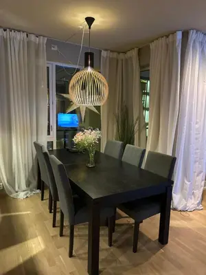 a dining room table with chairs and a chandelier at Splitter ny, romslig leilighet sentralt på Nyhavna leies ut in Trondheim