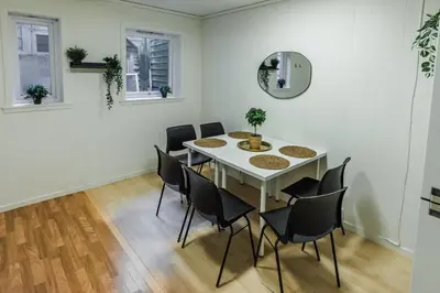 a dining room with a white table and chairs at Stylish place in the heart of Bergen in Bergen