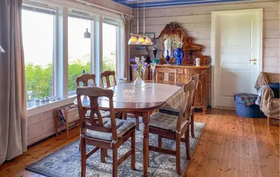 a dining room with a wooden table and chairs at Nice Home In Farstad With Wifi in Farstad