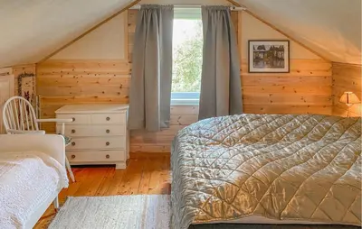 a bedroom with a bed and a window at Nice Home In Farstad With Wifi in Farstad