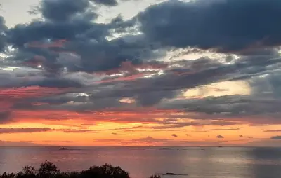 a sunset over the ocean with clouds at Nice Home In Farstad With Wifi in Farstad