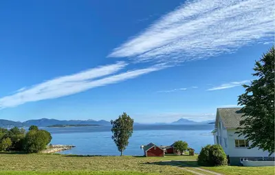 a house on the shore of a large body of water at 3 Bedroom Stunning Home In Fiksdal in Fiksdal