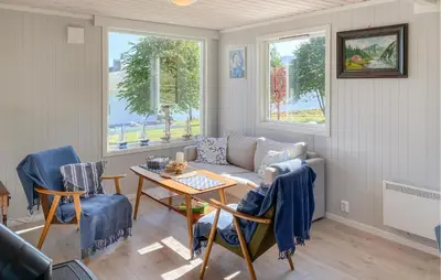 a living room with a couch and a table at 3 Bedroom Stunning Home In Fiksdal in Fiksdal