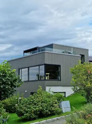 a large house with glass windows on top of it at Ski VM 2025 Eksklusivt hus in Trondheim