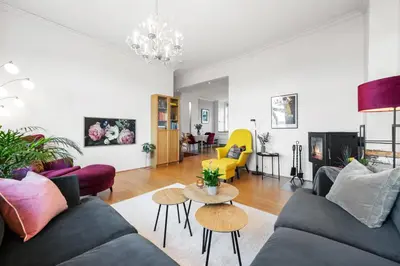 a living room with a couch and a table at Sentral og stilfull leilighet in Bergen