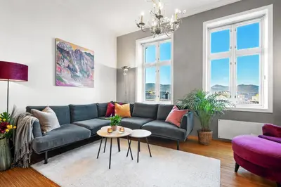 a living room with a couch and a table at Sentral og stilfull leilighet in Bergen