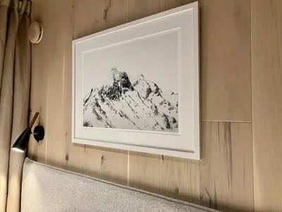 a framed picture of a mountain on a wall at Glimre Romsdal - Eksklusivt speilhus ved Åndalsnes in Isfjorden