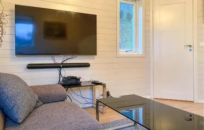 a living room with a couch and a flat screen tv at Beautiful Home In Skodje in Vatne