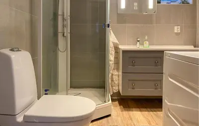 a bathroom with a shower and a toilet and a sink at Beautiful Home In Skodje in Vatne