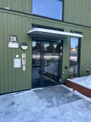 an entrance to a building with a glass door at Heimdal Sentrum in Heimdal