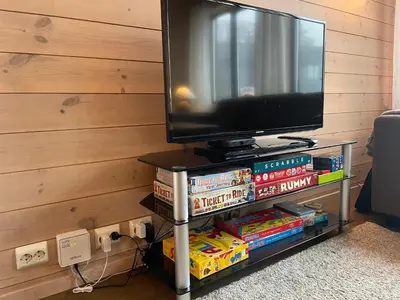 a tv sitting on top of a shelf with books at Perfect Family Base In Beitostølen in Beitostøl