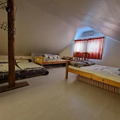 a room with three bunk beds and a window at Captivating 6-Bed Cottage in Lismarka in Haugen