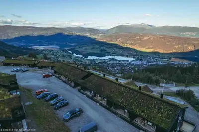 arial view of a parking lot with cars parked at Oppgradert leilighet i Tråstølen in Skulestadmo