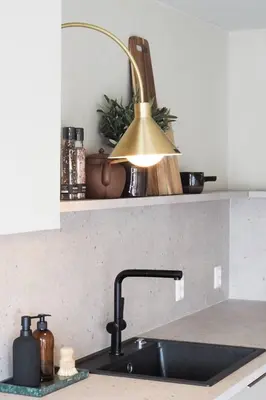 a kitchen sink with a lamp on top of it at Måløy Fjordbuer moderne og luksuriøse med havutsikt in Måløy