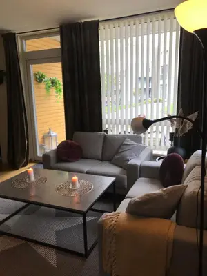 a living room with a couch and two tables with candles at Ski VM i Trondheim 2025 in Trondheim
