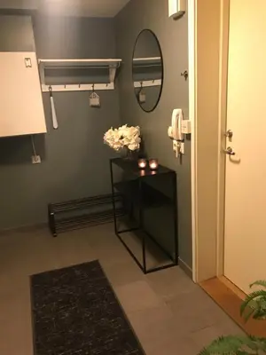 a room with a table with flowers and a mirror at Ski VM i Trondheim 2025 in Trondheim