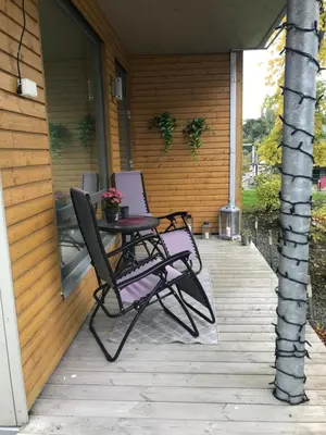 a patio with two chairs and a table on a porch at Ski VM i Trondheim 2025 in Trondheim