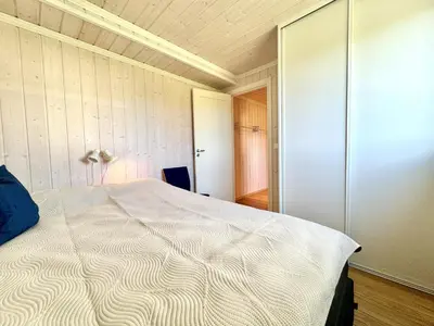 a bedroom with a large white bed in it at Modern apartment in the heart of Geilo center in Geilo