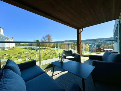 a living room with a blue couch and a table at Modern apartment in the heart of Geilo center in Geilo