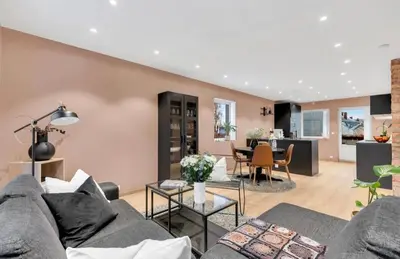 a living room with a couch and a table at Upgraded 3 bedroom apartment, close to WC-25 in Trondheim