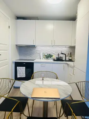 a kitchen with a table and chairs in a room at Trondheim- free parking in Høiset