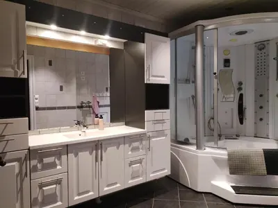 a white bathroom with a sink and a shower at Hessdalen hytte in Vårhus