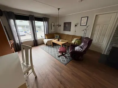 a living room with a couch and chairs and a table at Cozy apartment near city center and nature in Kristiansund