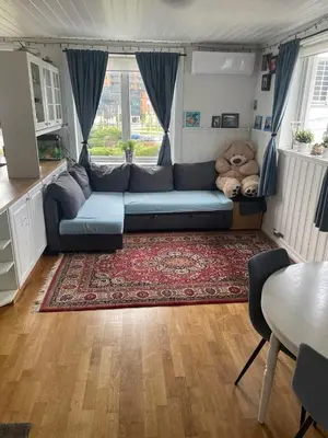 a living room with a couch and a large teddy bear at Bergen peaceful loft in Bergen