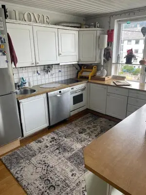 a kitchen with white cabinets and a counter top at Bergen peaceful loft in Bergen
