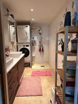 a bathroom with a sink and a washing machine at Bergen peaceful loft in Bergen