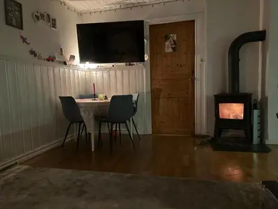 a living room with a table and a wood stove at Bergen peaceful loft in Bergen