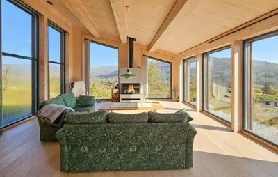 a living room with a couch and some windows at Nice Home In Edland With Sauna in Nesland
