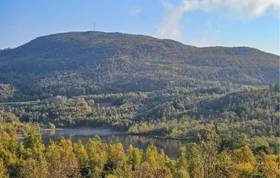 a mountain with a lake in front of it at Nice Home In Edland With Sauna in Nesland