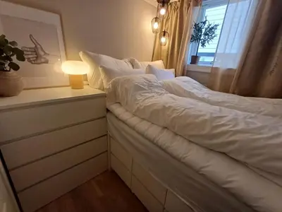 a bedroom with a large white bed with a window at Ytre Markveien 37 in Bergen