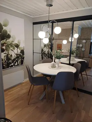 a dining room with a white table and chairs at Ytre Markveien 37 in Bergen