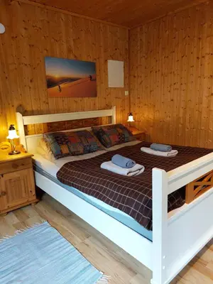 a bedroom with a bed with two towels on it at Eidsdal Camping og Feriehus in Eidsdal