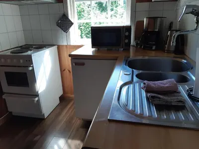 a kitchen with a sink and a stove top oven at Eidsdal Camping og Feriehus in Eidsdal