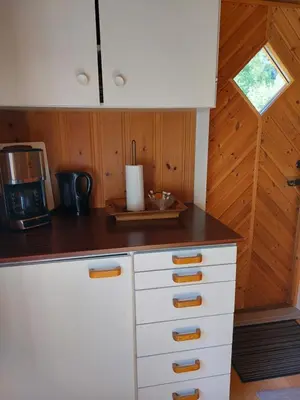 a kitchen with white cabinets and a counter top at Eidsdal Camping og Feriehus in Eidsdal